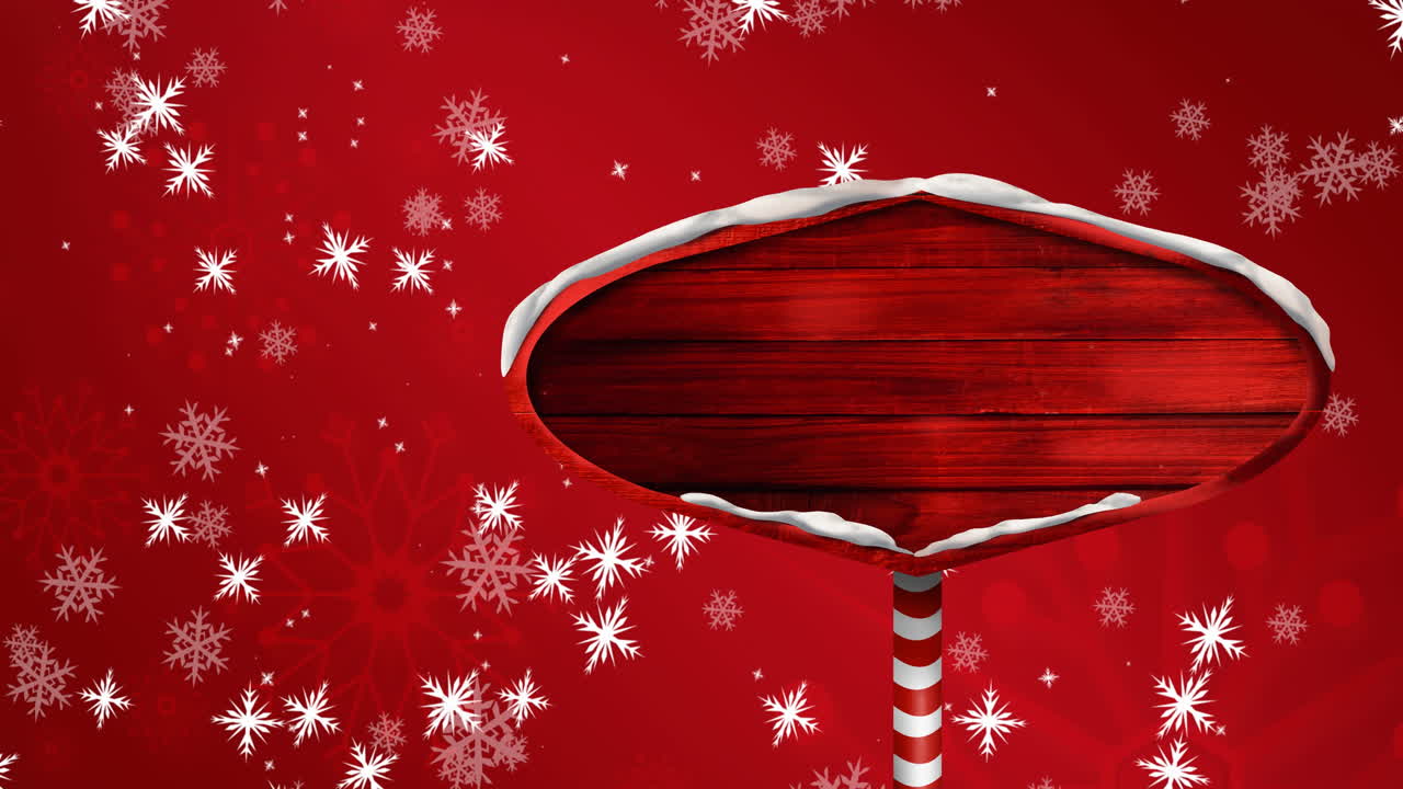 Animation of road sign with copy space and snow falling at christmas, over red background