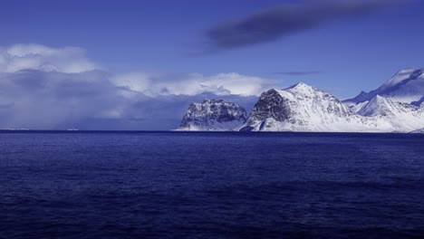 Wolken-Nähern-Sich-Schneebedeckten-Bergen-Am-Meer