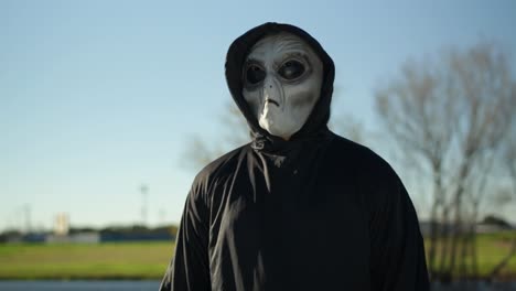 guy in alien costume standing in a park