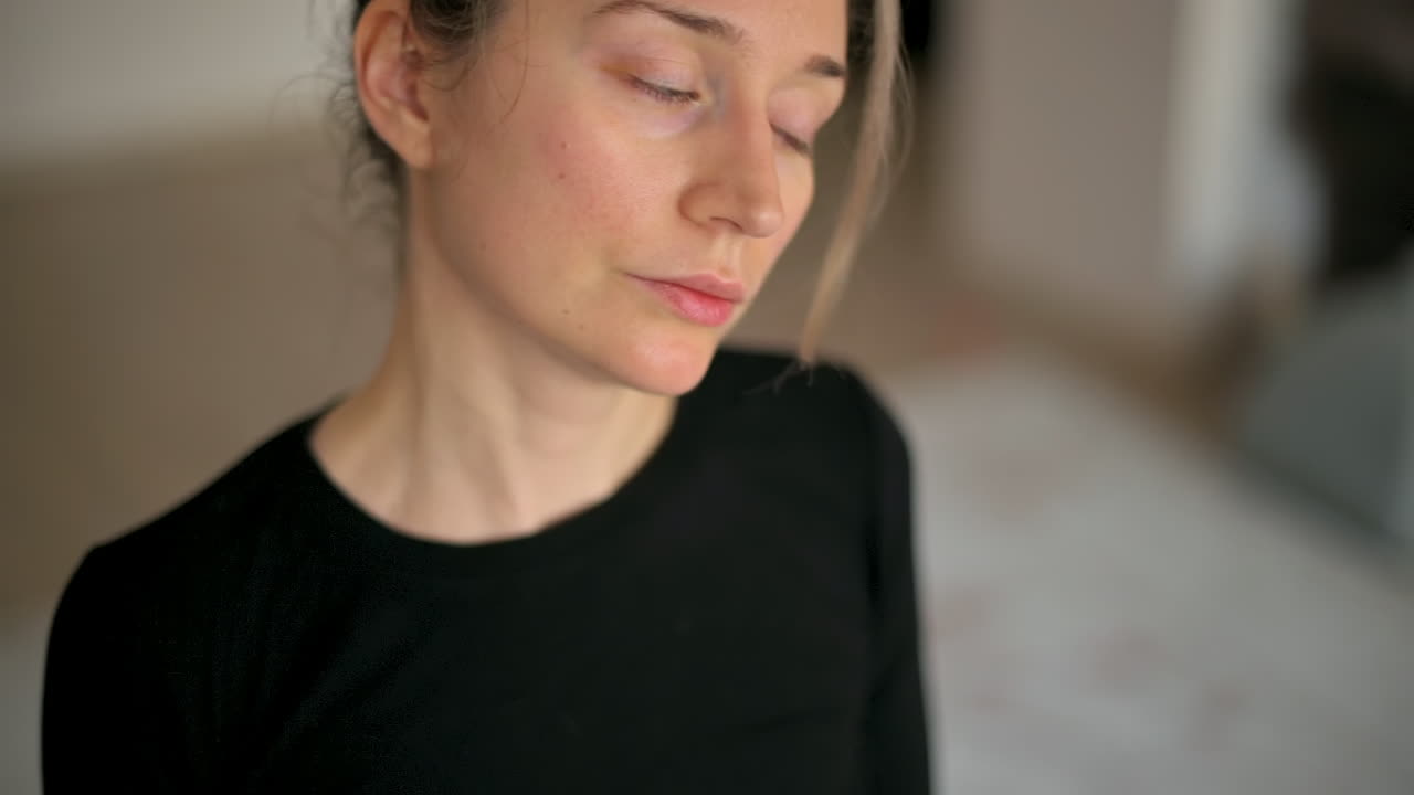 Close up of a woman in sportswear stretching at home