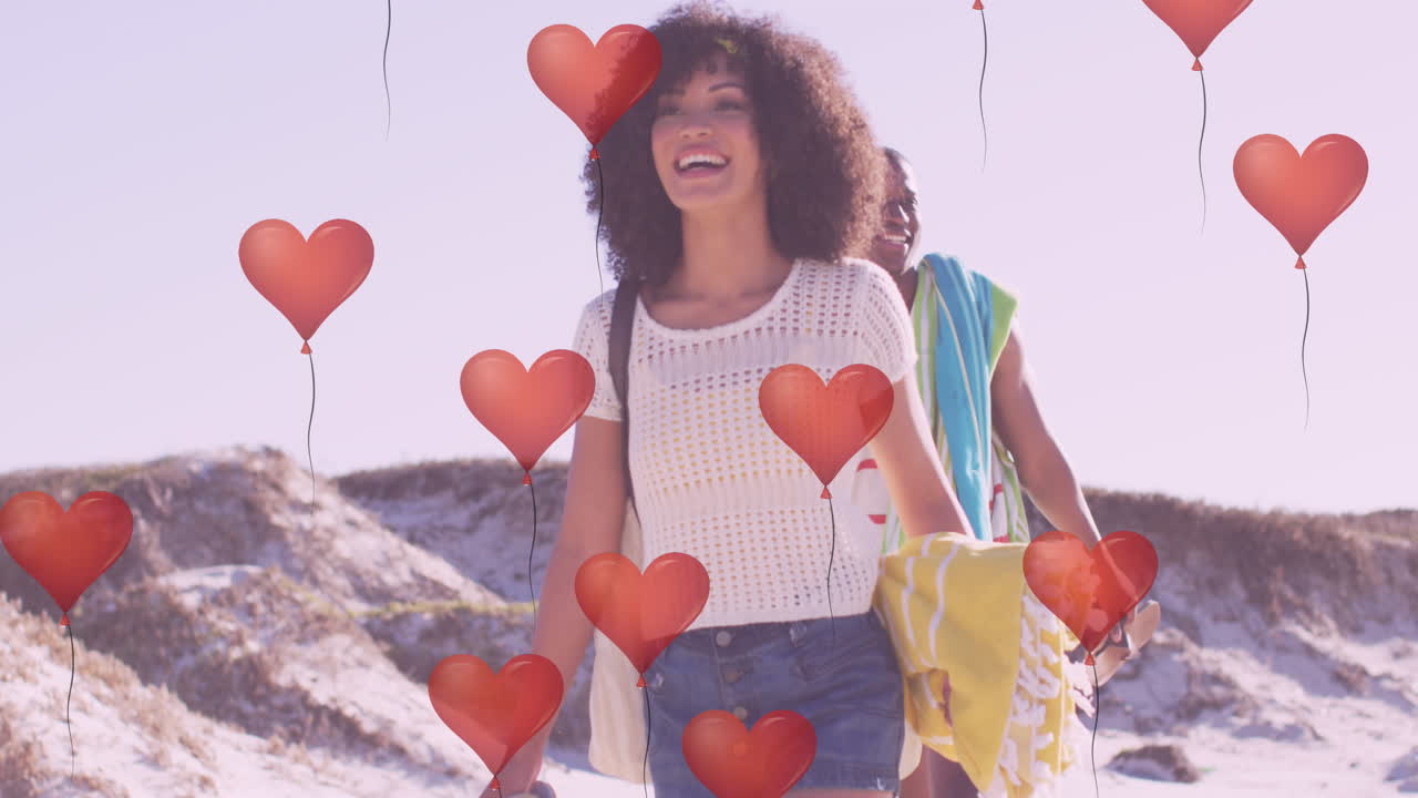 animación de corazones sobre una feliz pareja afroamericana en la playa