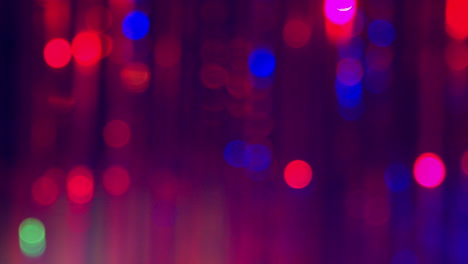 defocused close up shot of sparkling tinsel curtain in night club or disco with flashing strobe lighting 1