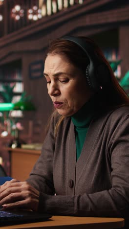 vertical video mature woman involved in a remote classroom experience via online platform