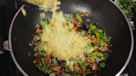 Recipe-of-an-Indian-Breakfast-Upma-preparation-adding-semolina-for-cooking