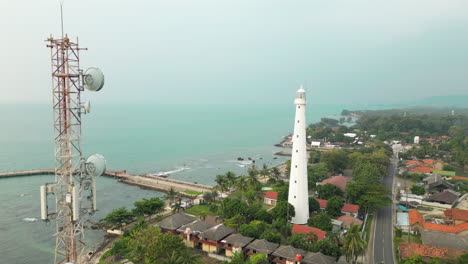 old lighthouse in cilegon indonesia as drone tracks inward at sunset 4k 60fps