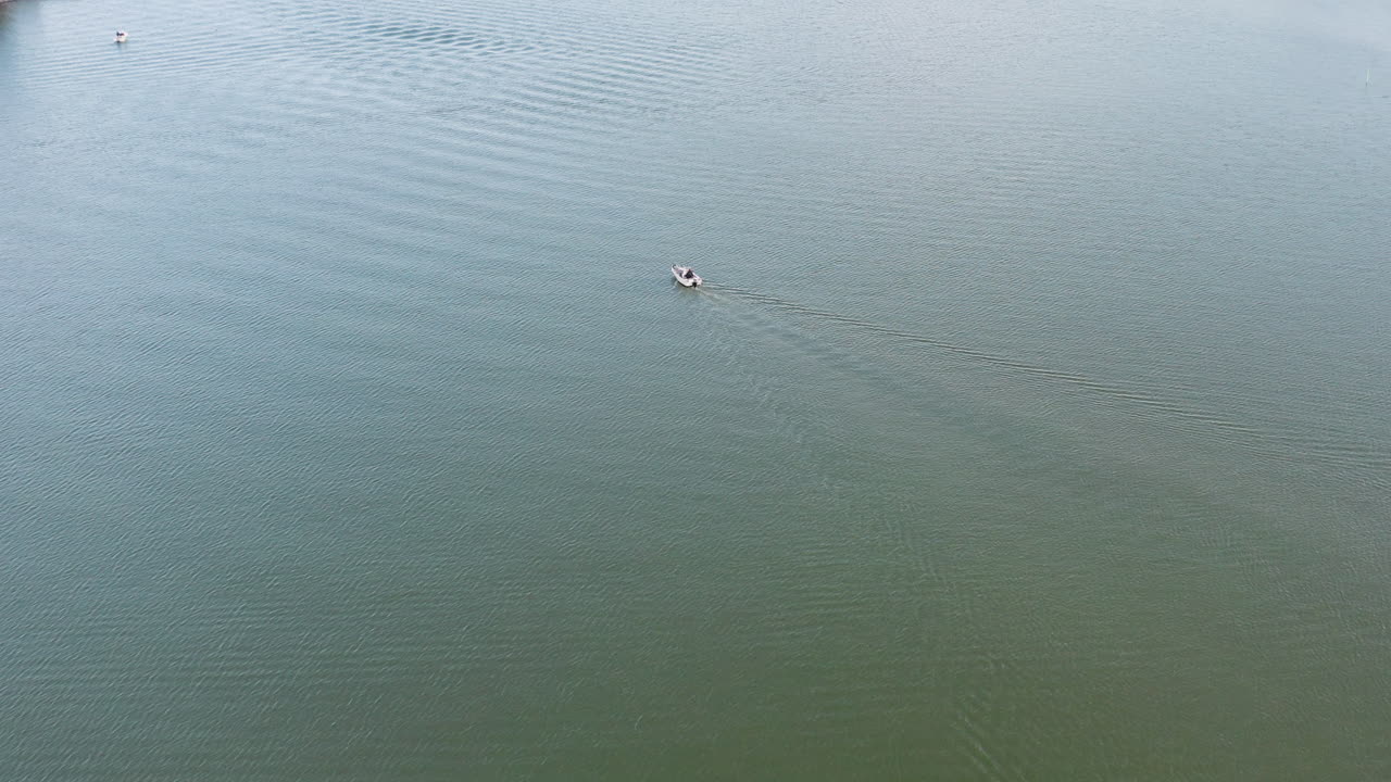 Flying over the picturesque Suviisaaristo or Sommaröarna a maritime district in Espoo, Finland with forested shoreline leading into waters sparsely filled with boats spending a recreational day