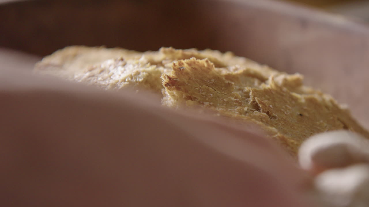 BAKING - Delicious, freshly baked sourdough bread, slow motion close up