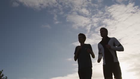 father and young adult son enjoying outdoor activities together