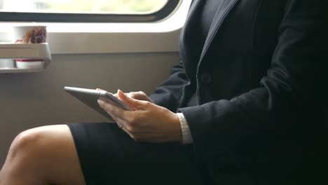 businesswoman using her tablet on the train