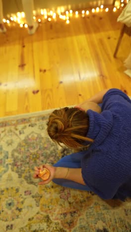 woman and baby sitting on rug in cozy room