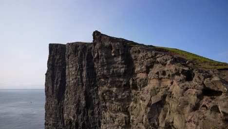 static shot of traelanipa cliff with some seagulls flying around