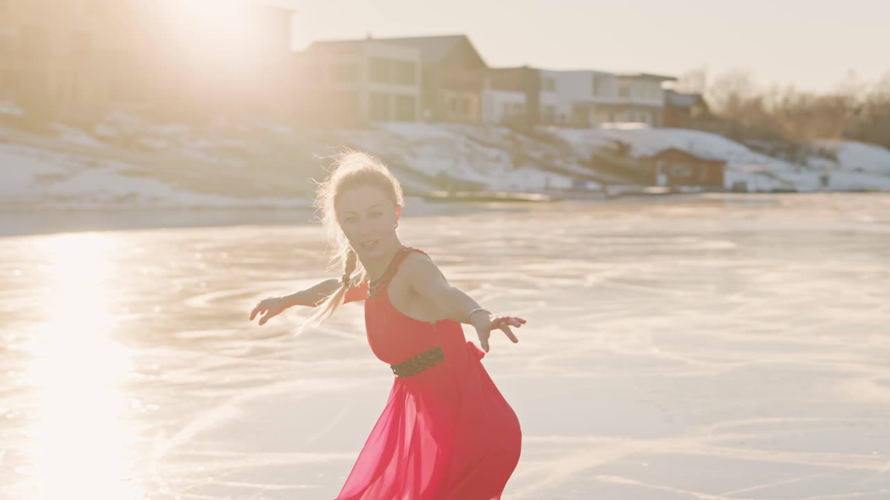 Woman Ice Skating on Frozen Lake in Red Dress