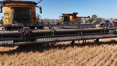 this footage captures the synergy of modern agricultural technology, showcasing the essential role of header fronts in the wheat harvesting process