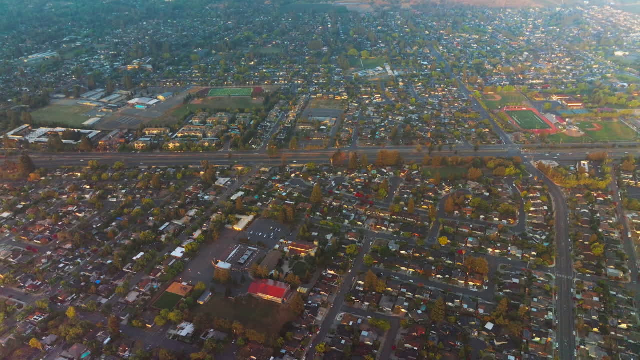 Urban panorama of densely built city. Napa, California, USA crossed by roads from aerial perspective at daytime.