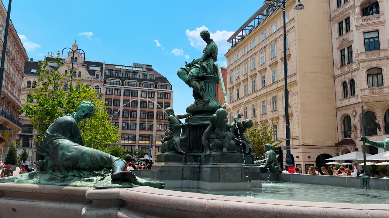 Vienna, Austria - June 9, 2025: Fountain with statues on the corners. Beautiful fountain in Vienna, Austria at the backdrop of old buildings