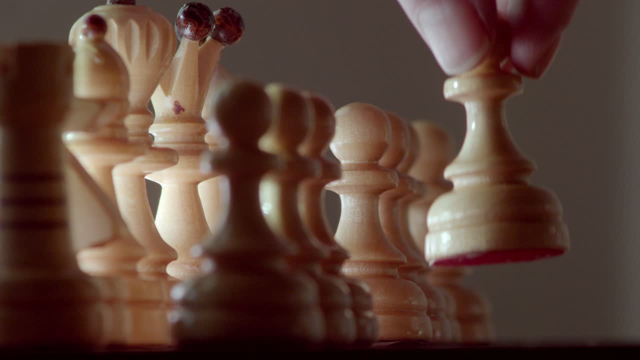 Chessboard game. Opening with a pawn. Close-up shot