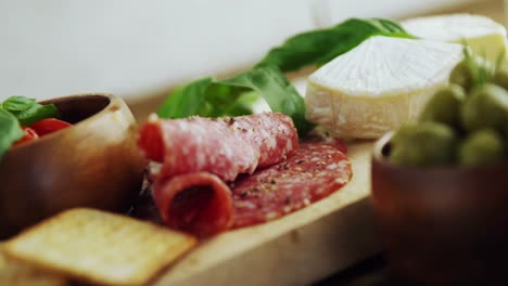 Wine-glasses-and-various-tapas-on-wooden-board