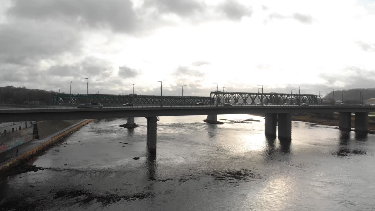 Evening after work day time view over sunlight and traffic on the bridge car motion above the river