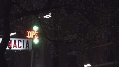 drugstore banner with led cross at night