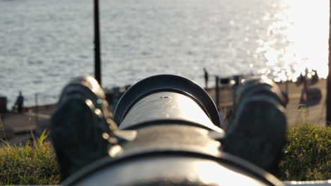 cannon at akershus fortress towards oslo fjord at sunset