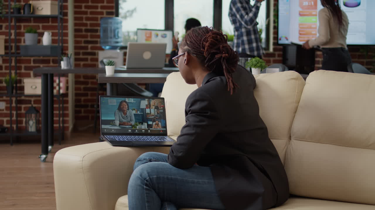 Young employee attending business meeting on videocall