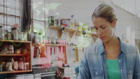 Animation-of-world-map-and-data-processing-over-caucasian-female-carpenter-working-in-workshop