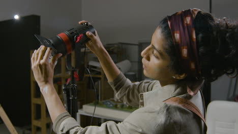 woman working on the lights in the studio