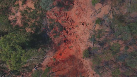 Aerial-shot,-dinosaur-footprints-filled-with-water-in-the-Australian-outback-desert