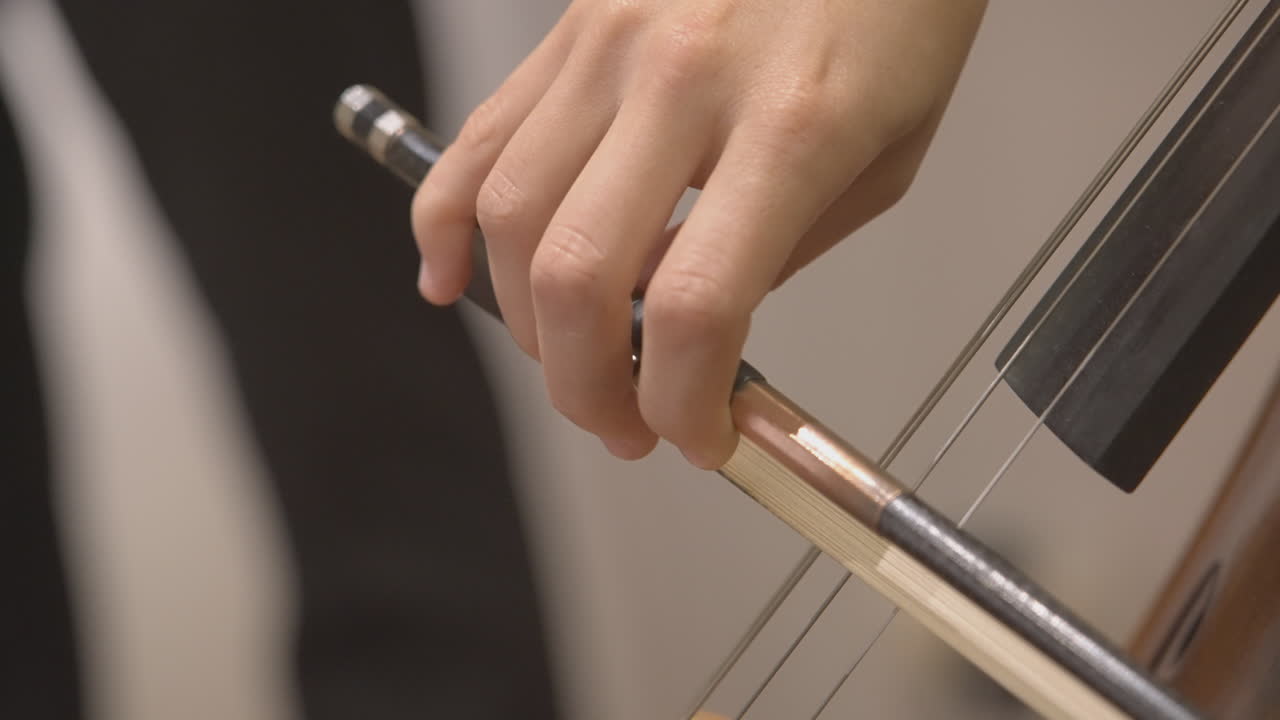 Close-up of Hand Playing Cello with Bow
