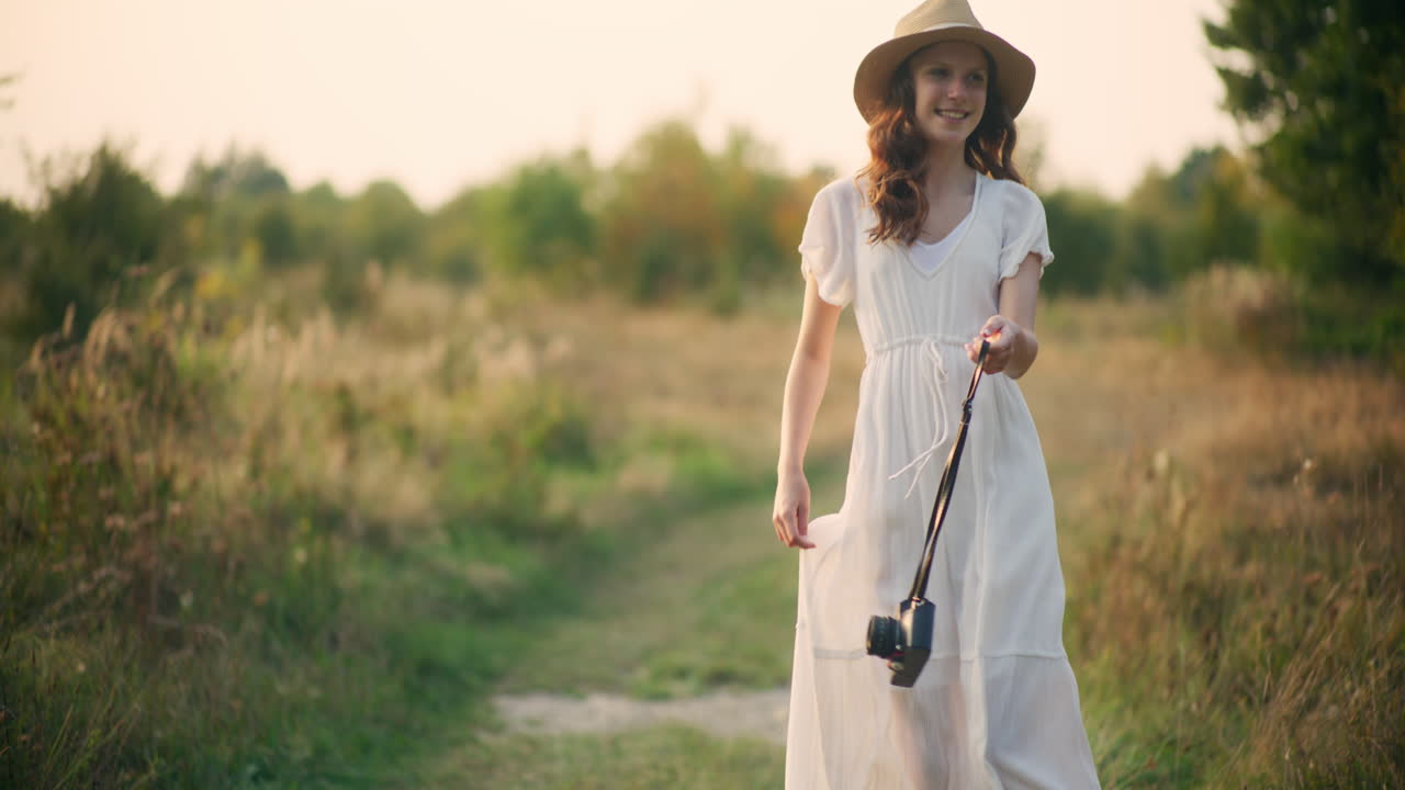 Child with film camera in a field of joy