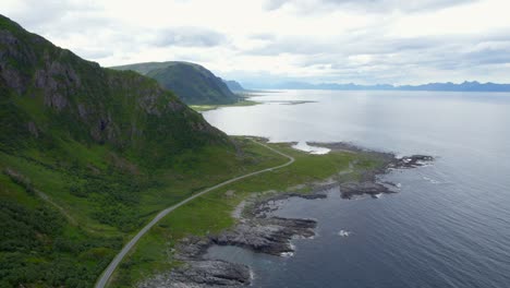 forward dolly shot of the anoya coasline and scenic route that follows the rocky coastline with breath taking views the mountains and the shoreline