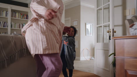 happy-little-boy-chasing-mother-with-teddy-bear-playing-catch-running-through-house-mom-enjoying-fun-game-with-child-enjoying-weekend-morning-together-4k-footage