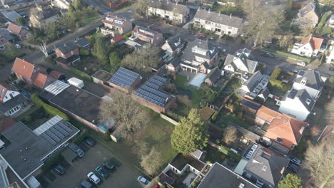 aerial of solar panels on rooftops of beautiful suburban neighborhood