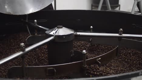 process of roasting coffee beans into industrial coffee roasting machine close up