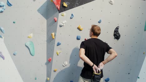 man climbing a bouldering wall