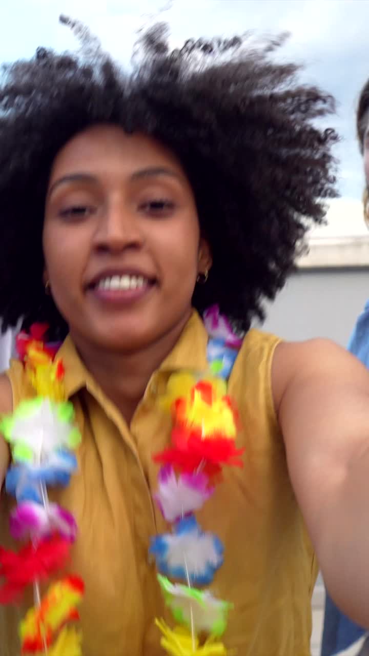 Woman with curly hair and Hawaiian lei taking a selfie