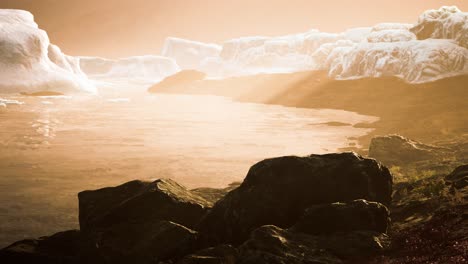 Antarctic-icebergs-near-rocky-beach