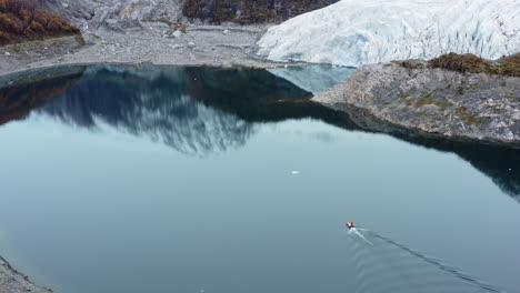 boat across tranquil waters of beagle channel in tierra del fuego archipelago, argentina. aerial drone shot