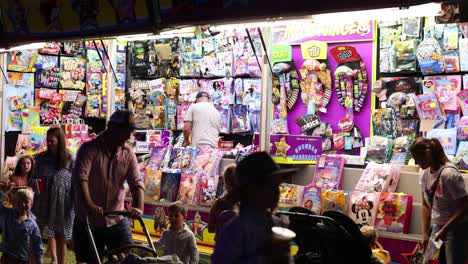 people playing games at a colorful carnival booth