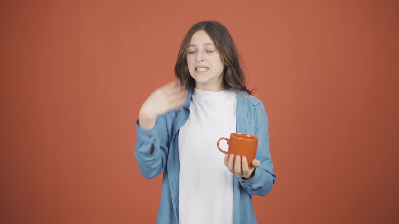 The young woman's mouth is burning from the hot drink.
