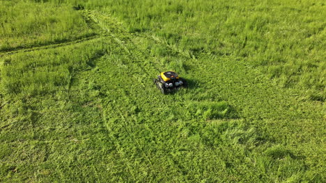 Aerial-View-of-Robotic-Automated-Lawn-Mower,-Machine-Cutting-Green-Grass,-Drone-Shot