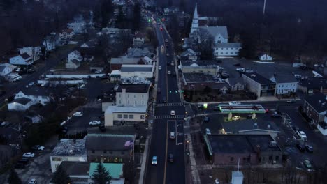 drone video of small town on the lake during winter and fall just after sunset, with houses and cars and an overcast sky and traffic