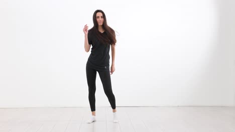 young woman posing in activewear in a studio