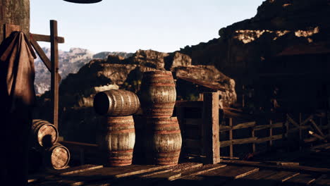 stacked wooden barrels on a wooden porch