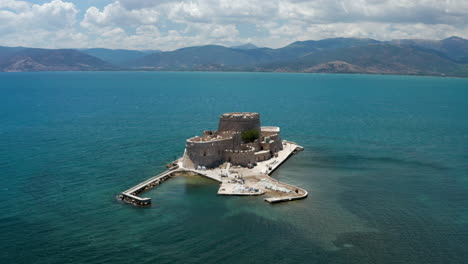 bourtzi fortress, a prison in the sea in front of nafplio town the first capital of greece - aerial drone shot