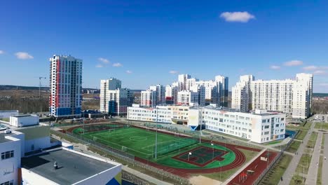 aerial view of residential area with school and sports facilities