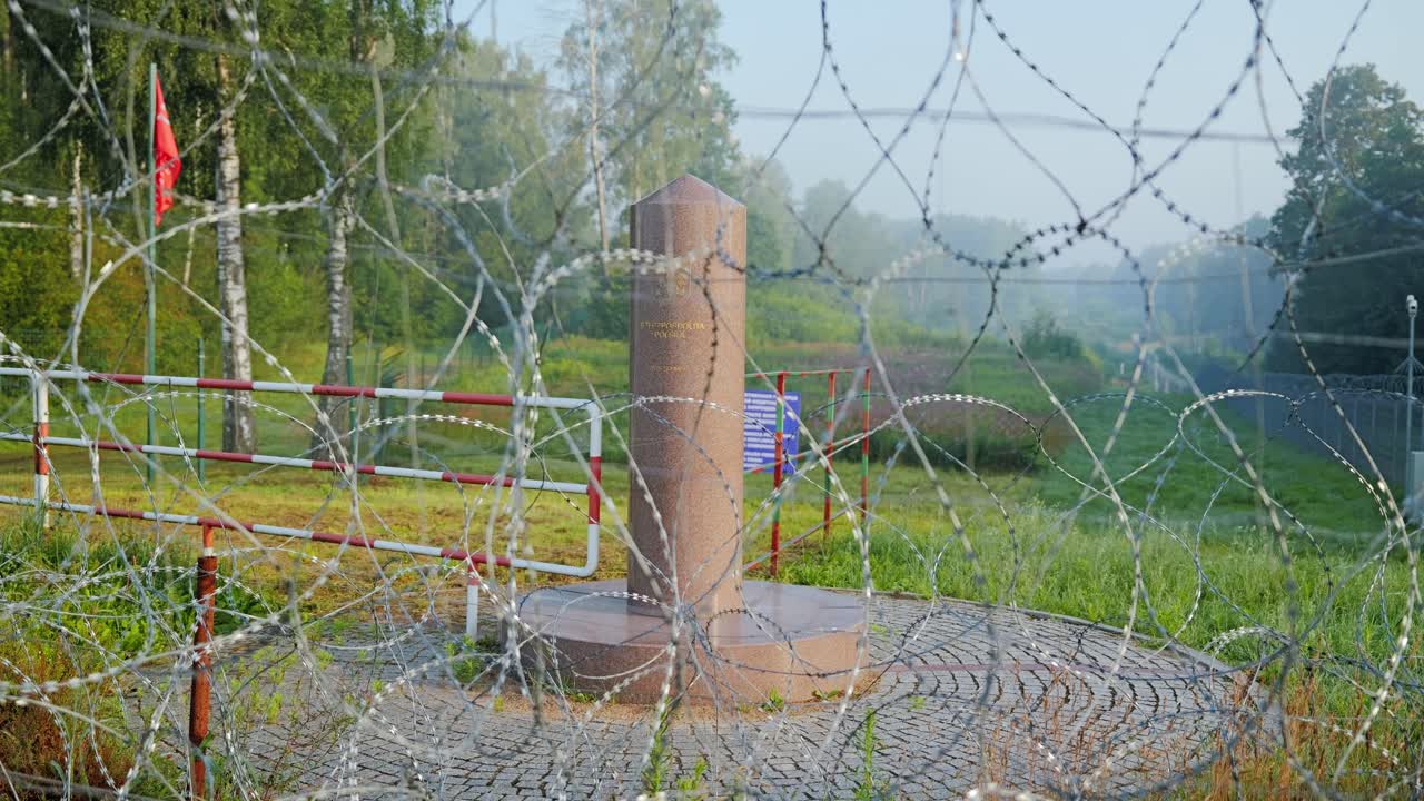 Symbolic view of border security showing wire fence and national marker