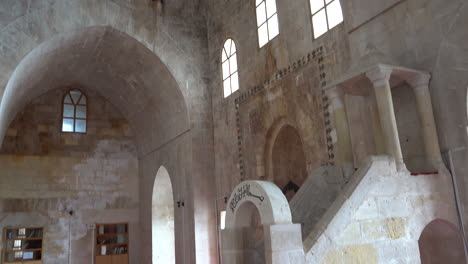 First,-we-see-the-hewn-stone-dome-and-walls-of-the-Zinciriye-Madrasa,-and-then-the-camera-moves-down-to-the-pulpit-made-of-cut-stone