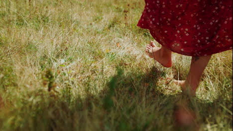 woman feet stepping grass close up. unknown girl walking alone on nature.