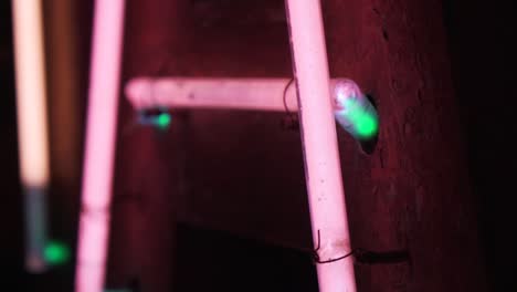 Close-pan-shot-of-a-detail-of-a-pink-neon-sign